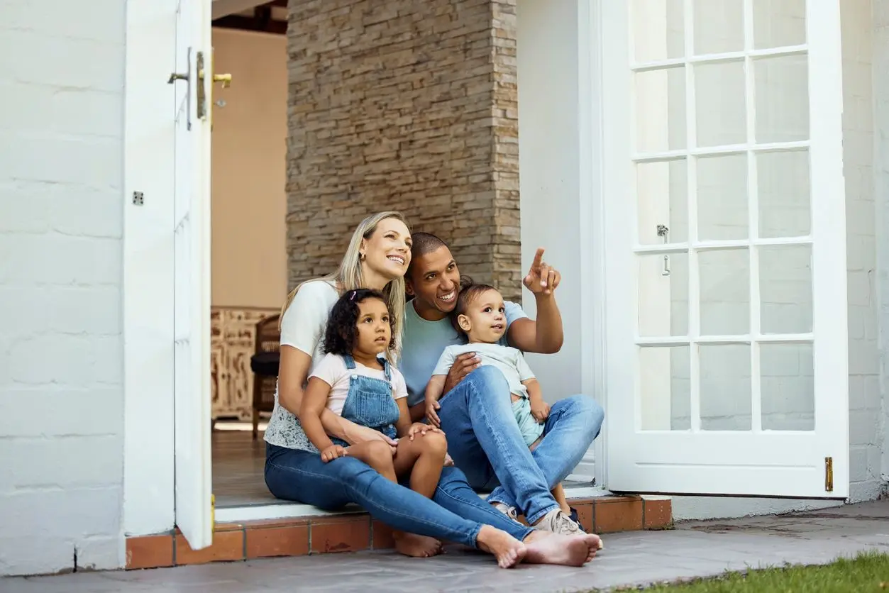 A family sitting outside, enjoying each other's company.