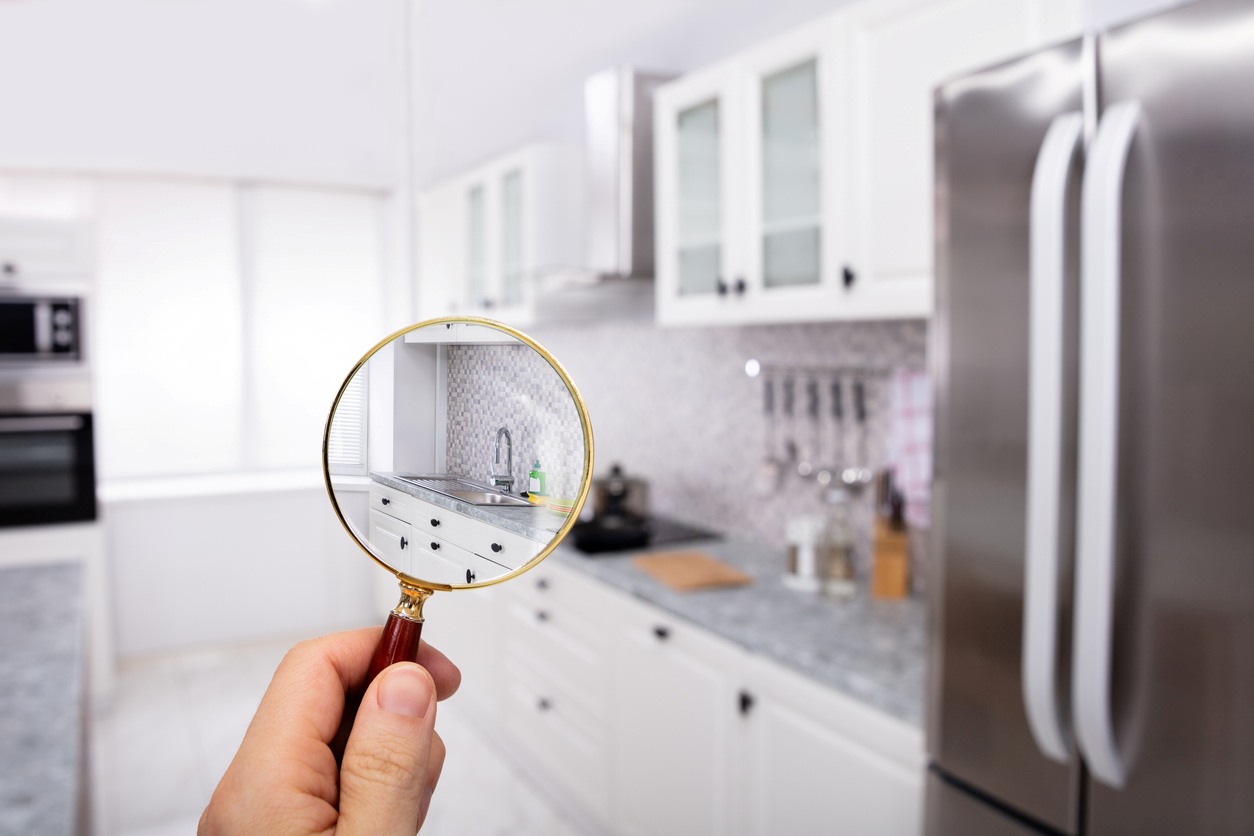 A magnifying glass zooming in on the sink in a modern kitchen.